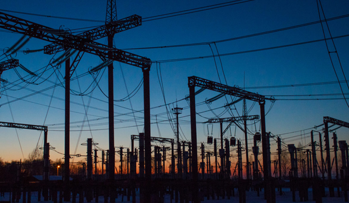 Power station at sunset showing a large fueling infrastructure.