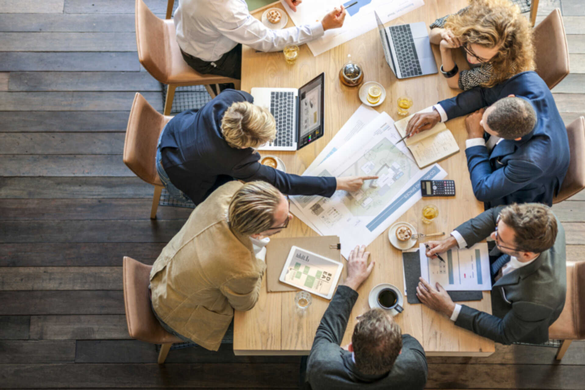 People Meeting Brainstorming and collaborating together at a large table.