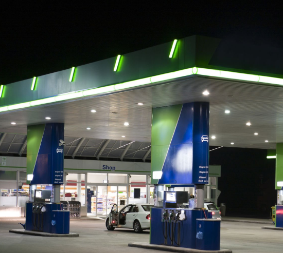 Well lit and large forecourt at night.