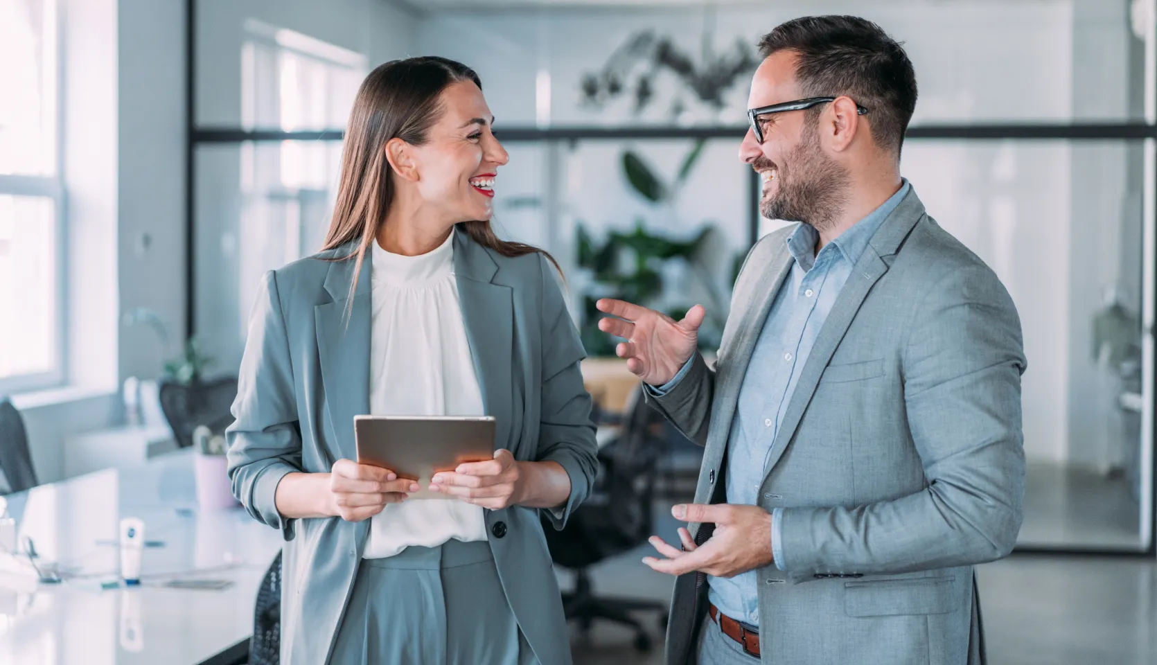 Woman and man sharing best practices to drive customer success and value.